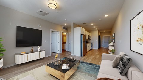 A living room with a white couch and a black coffee table.