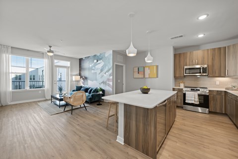 A modern kitchen with wooden cabinets and a large island.