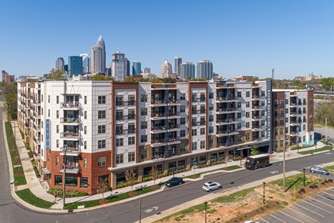 A view of a city with apartment buildings in the foreground.