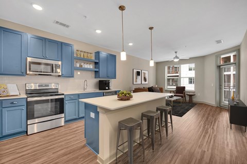A kitchen with blue cabinets and a white island.