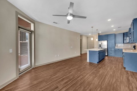 A room with wooden flooring and a ceiling fan.