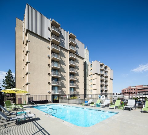 A large building with a pool in front.