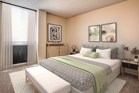 A bedroom with a large bed, a bench, and two pictures on the wall.