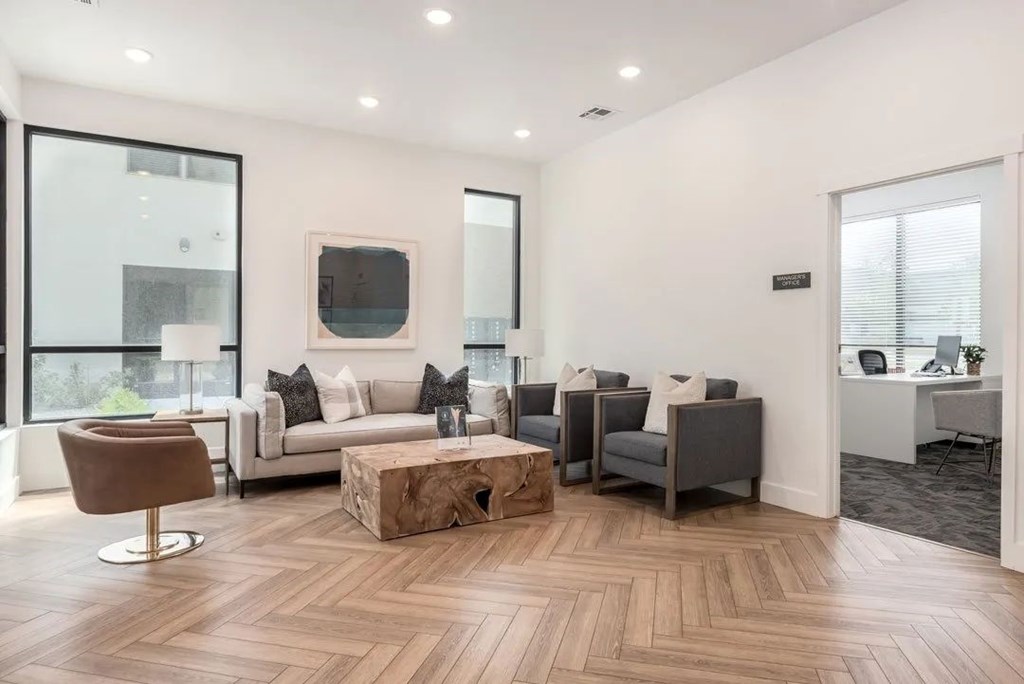 A living room with a brown chair and a white couch.
