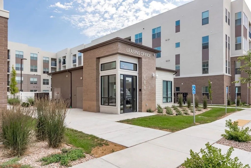 A building with a glass door and a sign that says