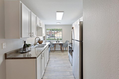 a kitchen with a sink and a refrigerator