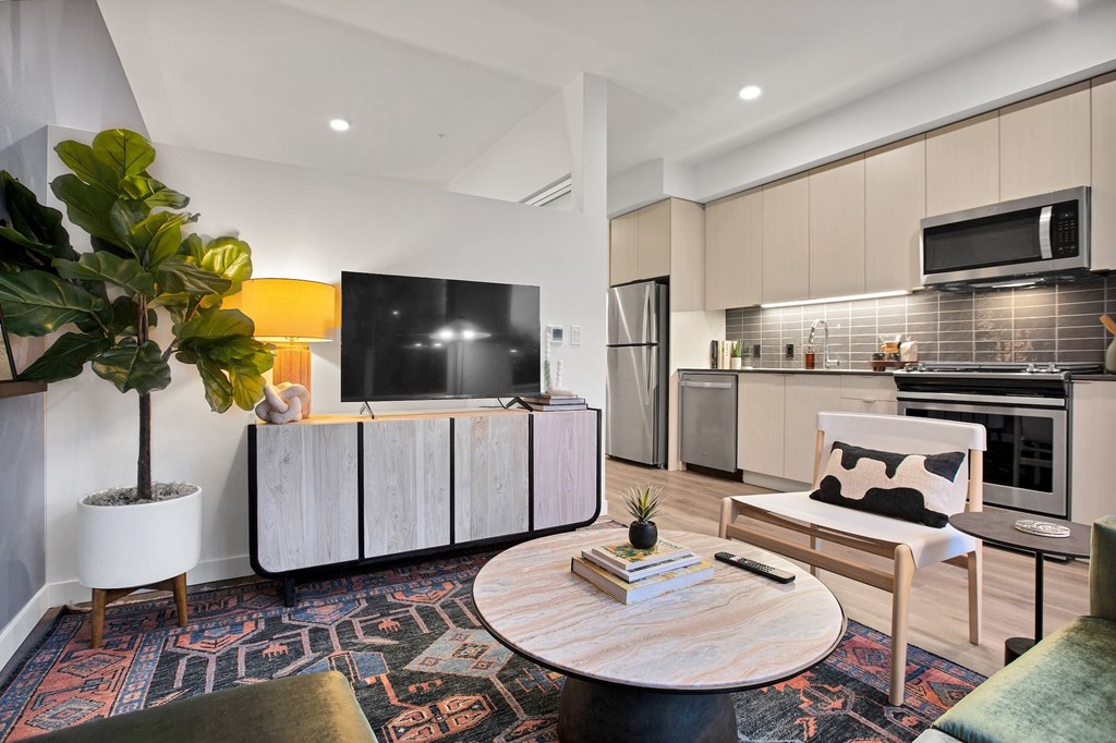A modern living room with a wooden coffee table and a white couch.