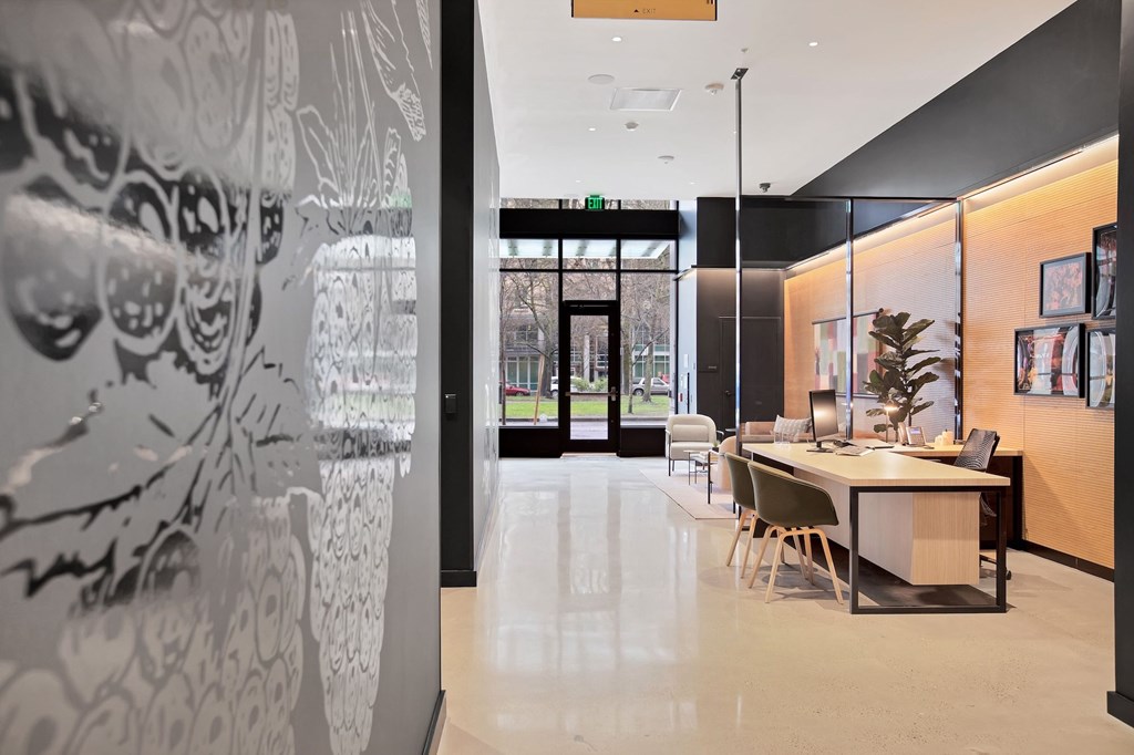 A white and black patterned wall is on the left side of a room with a table and chairs.