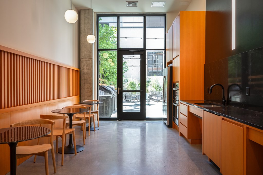 MERX Slabtown's co-working area with a resident kitchen, seating, Pacman game, and little library.