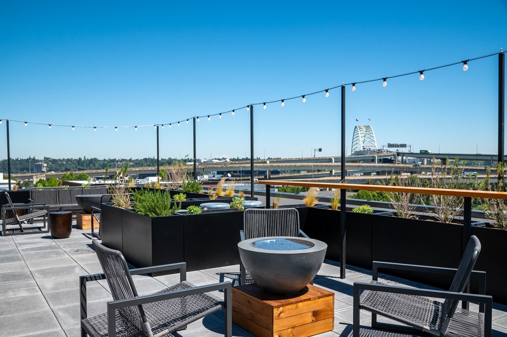 Rooftop patio with a fire pit and chairs in the heart of Portland Oregon's beloved Slabtown neighborhood.