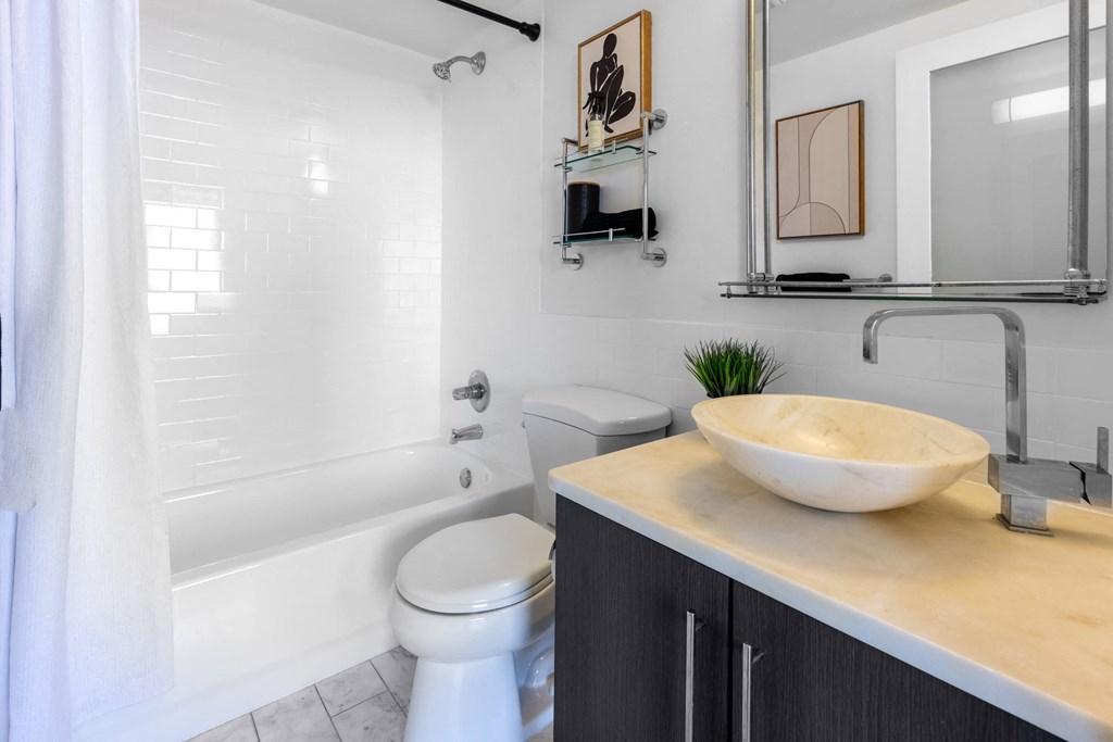 a bathroom with a sink and a toilet and a tub