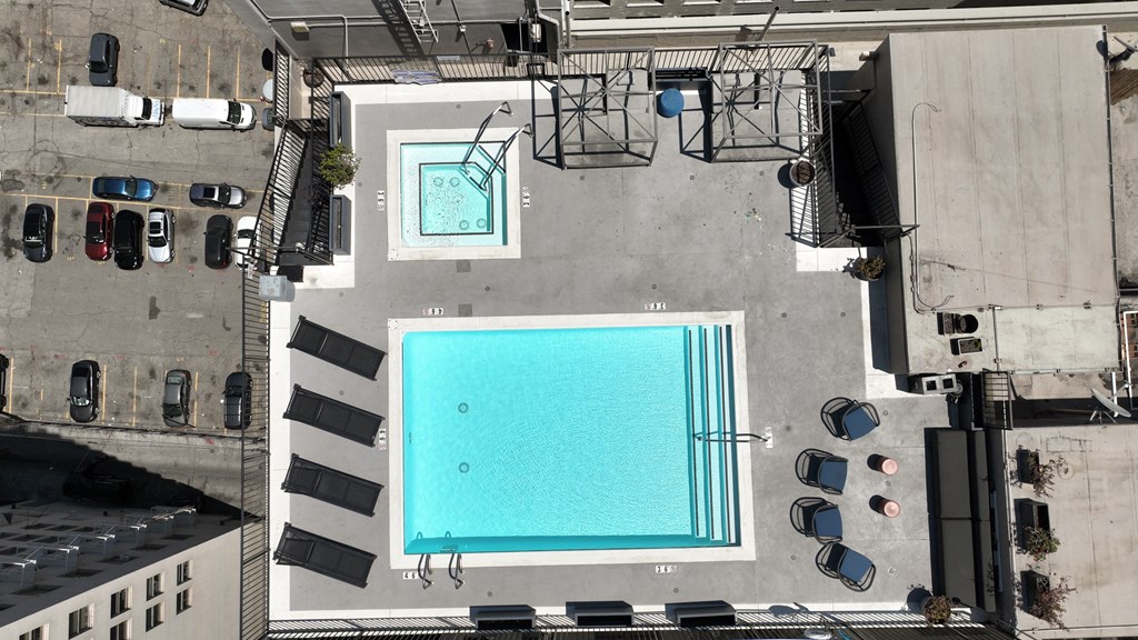 an aerial view of a swimming pool on the side of a building