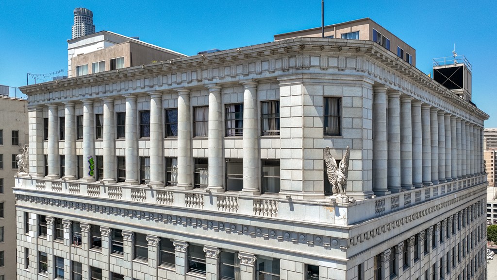 a large white building with a statue of a lion in front of it
