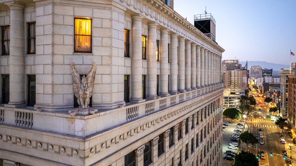 a large white building with a statue on the side of it