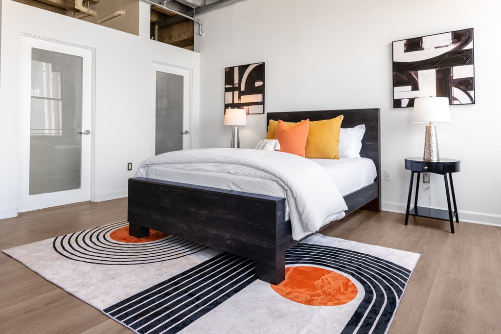 a bedroom with a bed and a rug