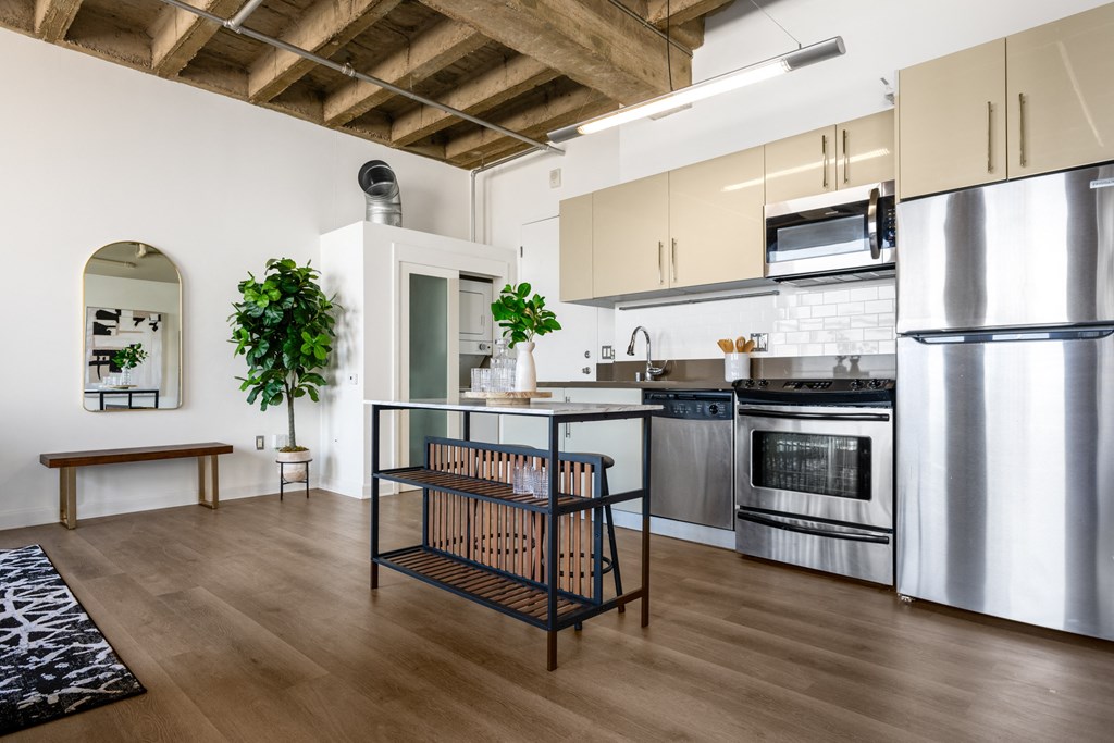 a kitchen with stainless steel appliances and white cabinets