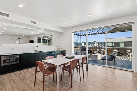 A modern kitchen with a dining table and chairs.