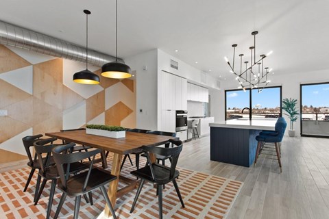 A modern dining room with a wooden table and chairs.