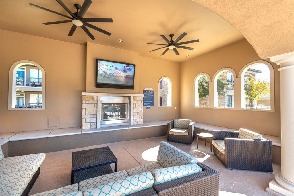 a living room with couches and chairs and a fireplace