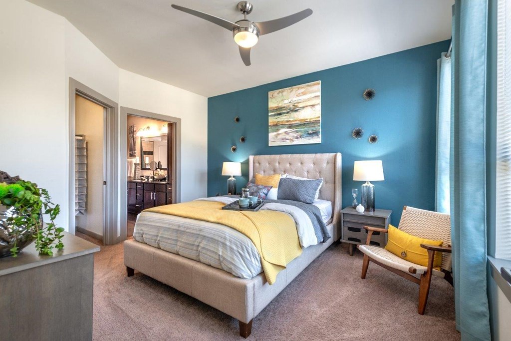 a bedroom with a bed and a ceiling fan