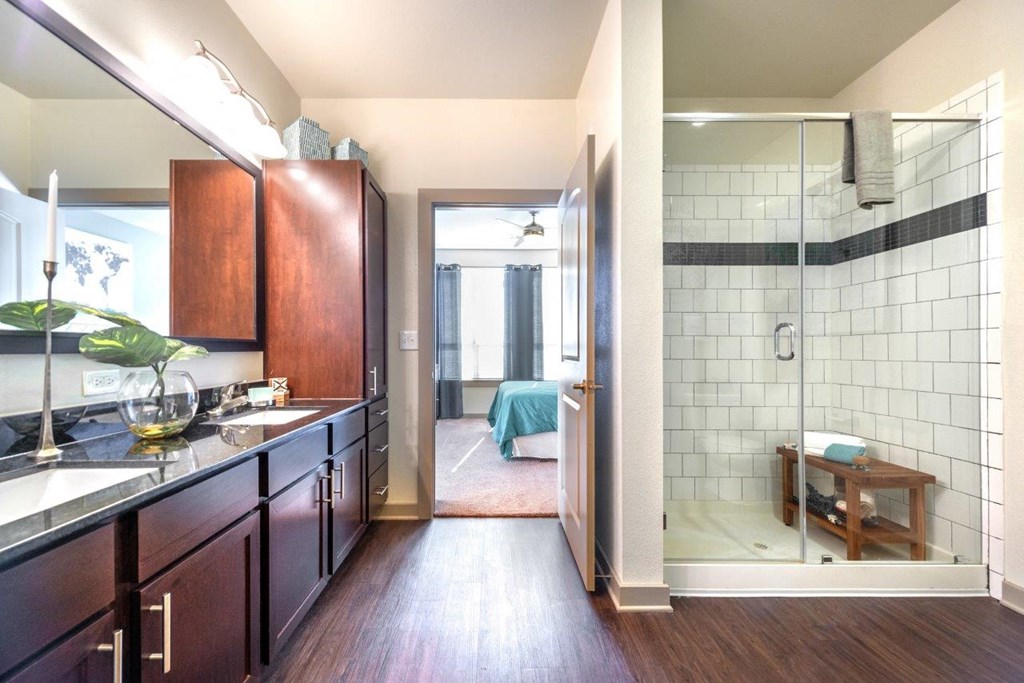 a bathroom with a walk in shower next to a sink