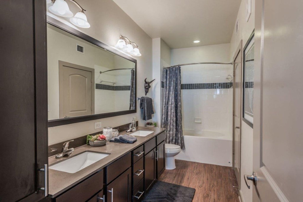 a bathroom with a shower toilet and sink