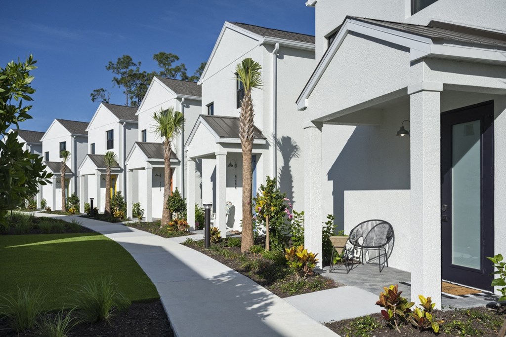 Argos by Soltura Rental Homes row of white houses with a yard and a chair