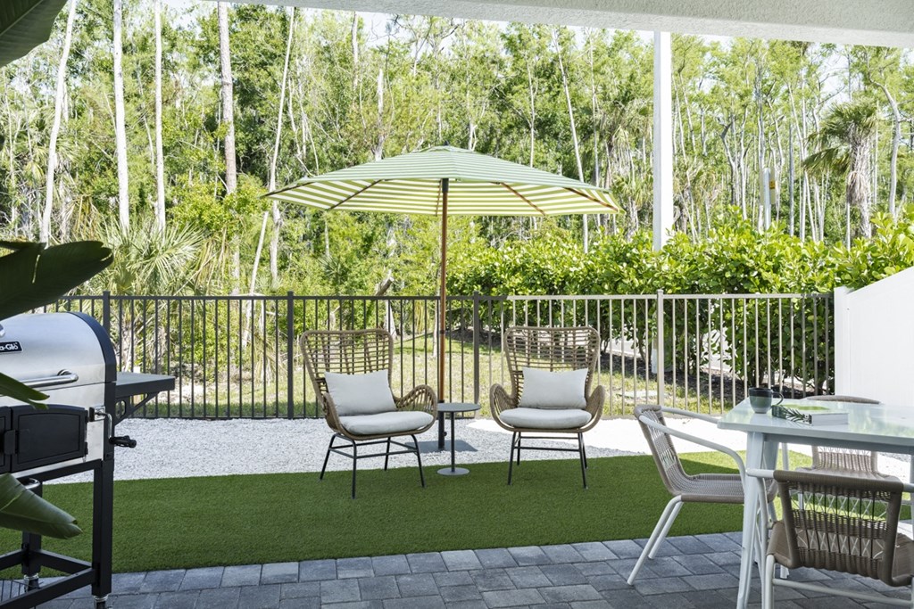 Argos by Soltura Rental Homes patio with chairs and an umbrella