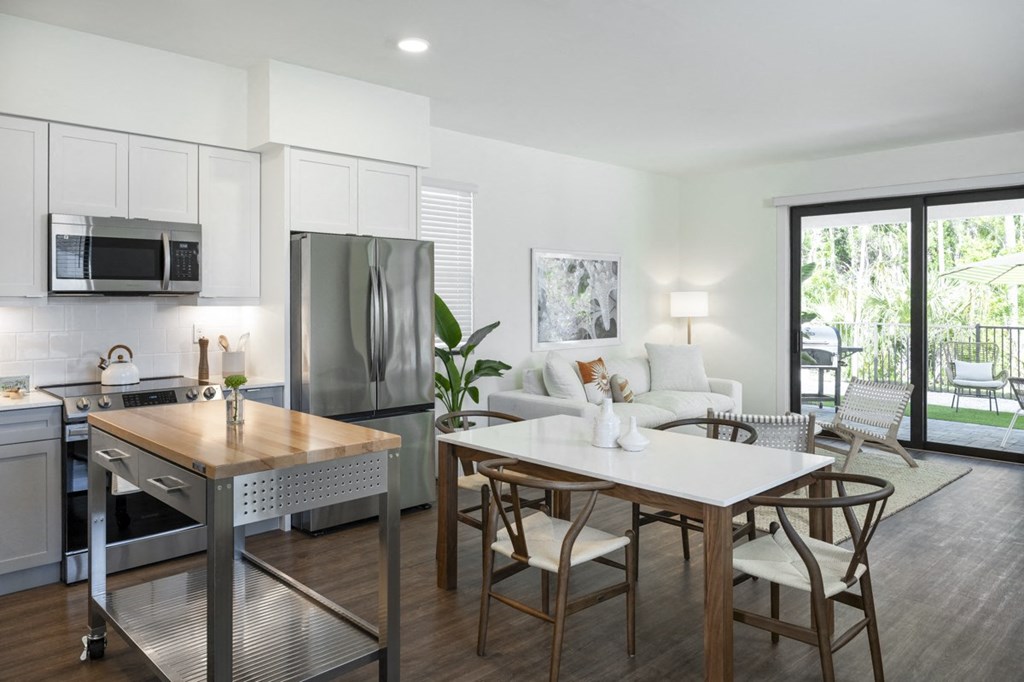 Argos by Soltura Rental Homes living room with a kitchen and a dining table