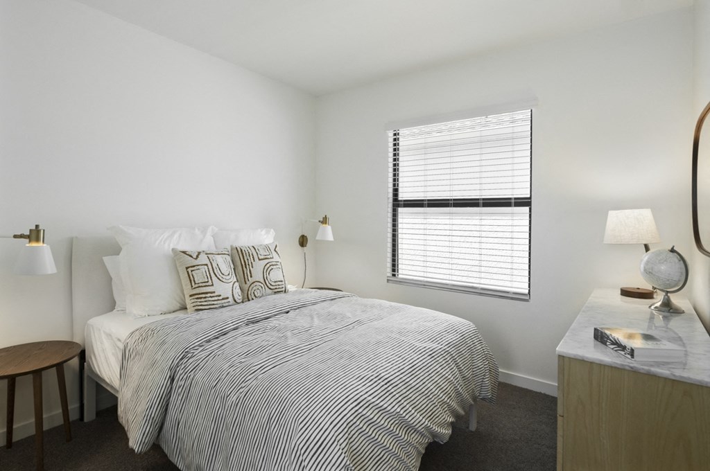 Argos by Soltura Rental Homes bedroom with a bed and a desk and a window