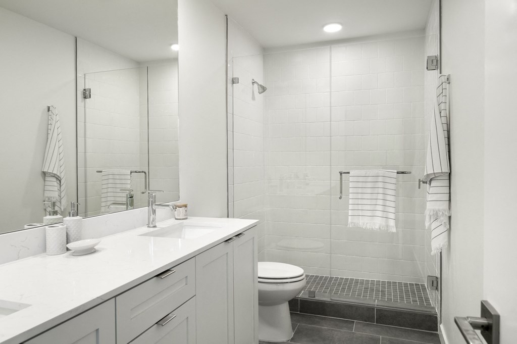 Argos by Soltura Rental Homes bathroom with a shower and a sink and a toilet