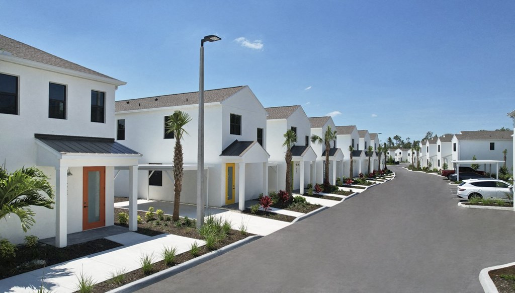 Argos by Soltura Rental Homes row of white houses with palm trees and a street