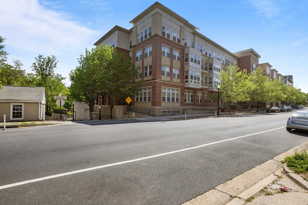 A street view of a residential area with apartment buildings.
