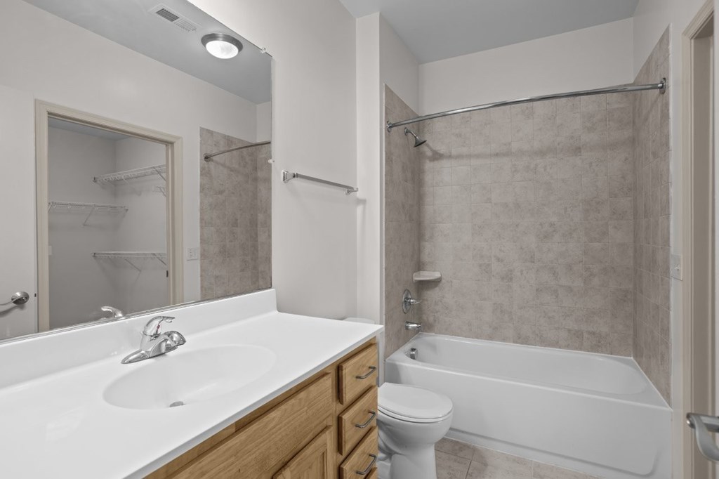 A white bathroom with a sink, toilet, and bathtub.