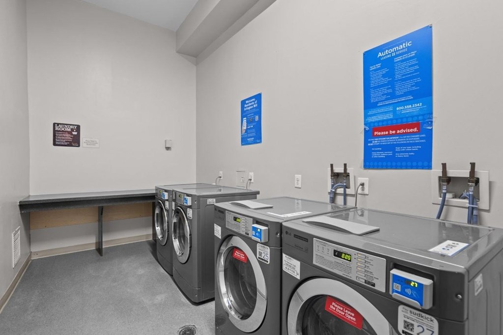 A row of washing machines in a laundromat.