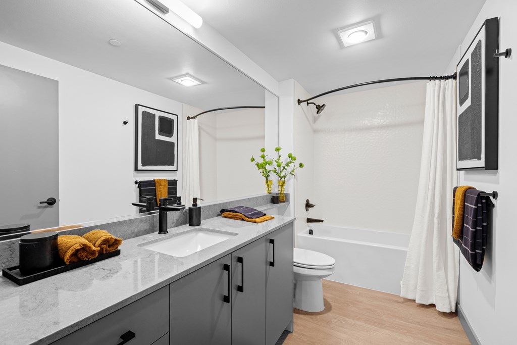 A bathroom with a white sink and a white toilet.