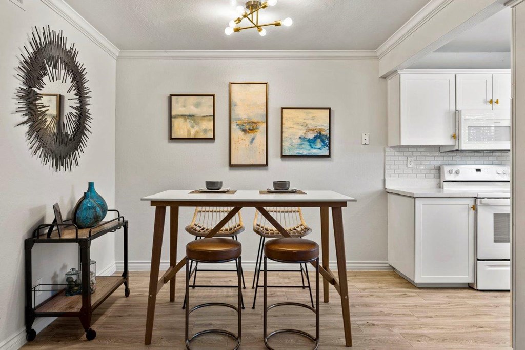 a kitchen with a table and two chairs