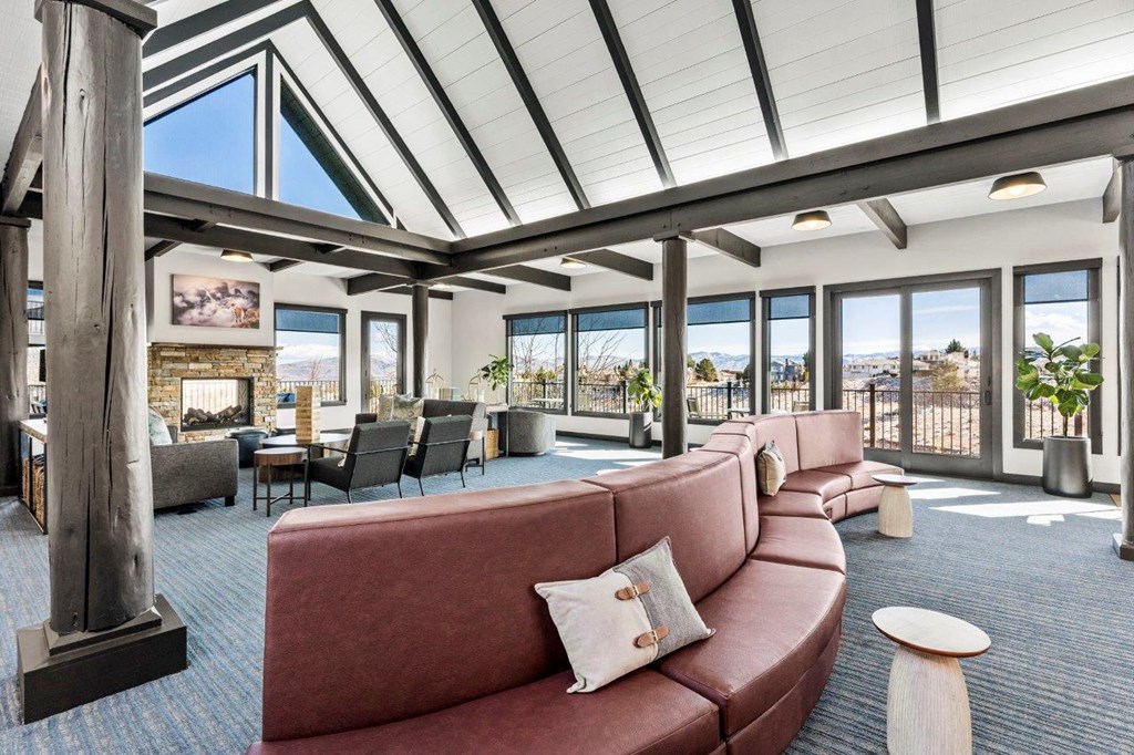 a large living room with couches and a table with chairs