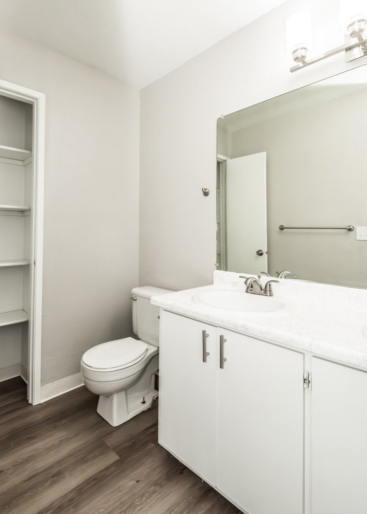 A white bathroom with a toilet, sink, and medicine cabinet.