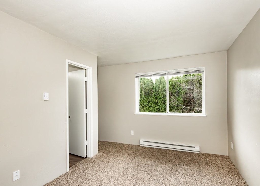 A room with a window and a door.