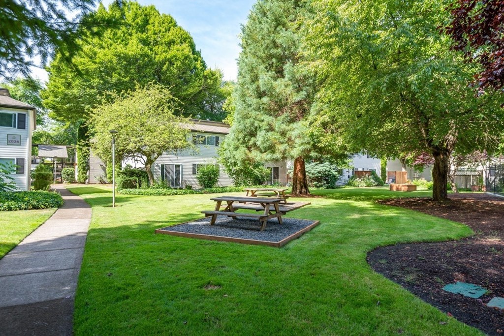 A picnic table sits in the middle of a grassy area.
