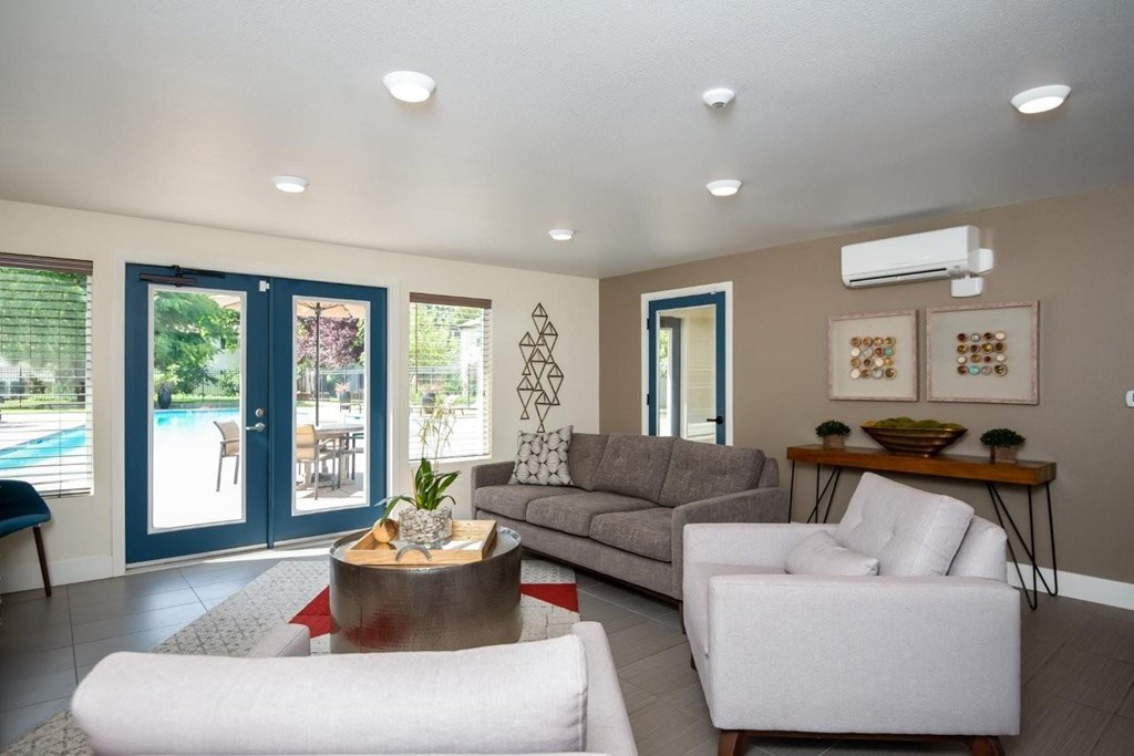 A living room with a white sofa, a grey couch, and a coffee table.