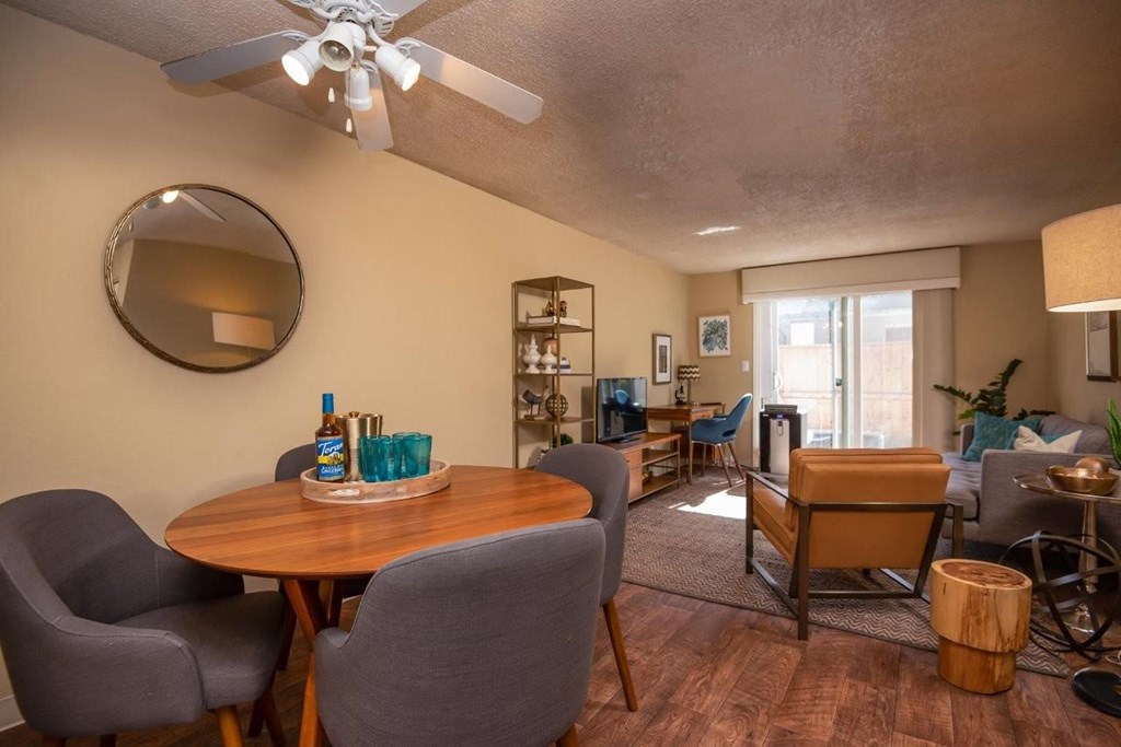 A living room with a dining table and chairs.