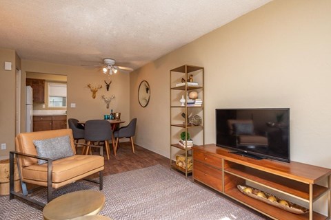 A living room with a brown chair and a brown table.