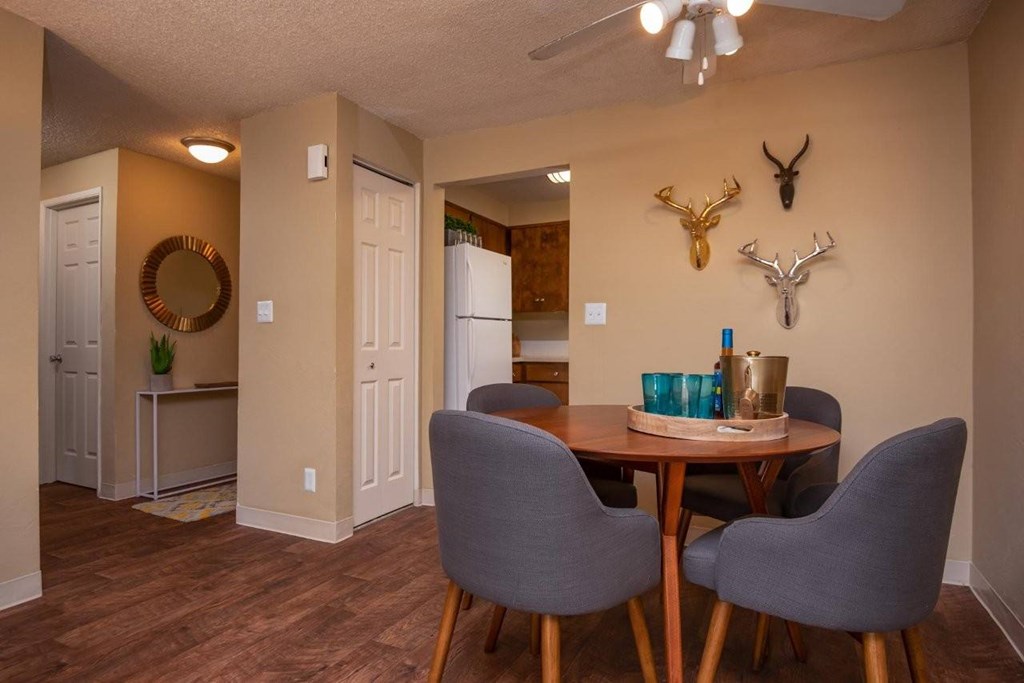 A dining room with a table and chairs.