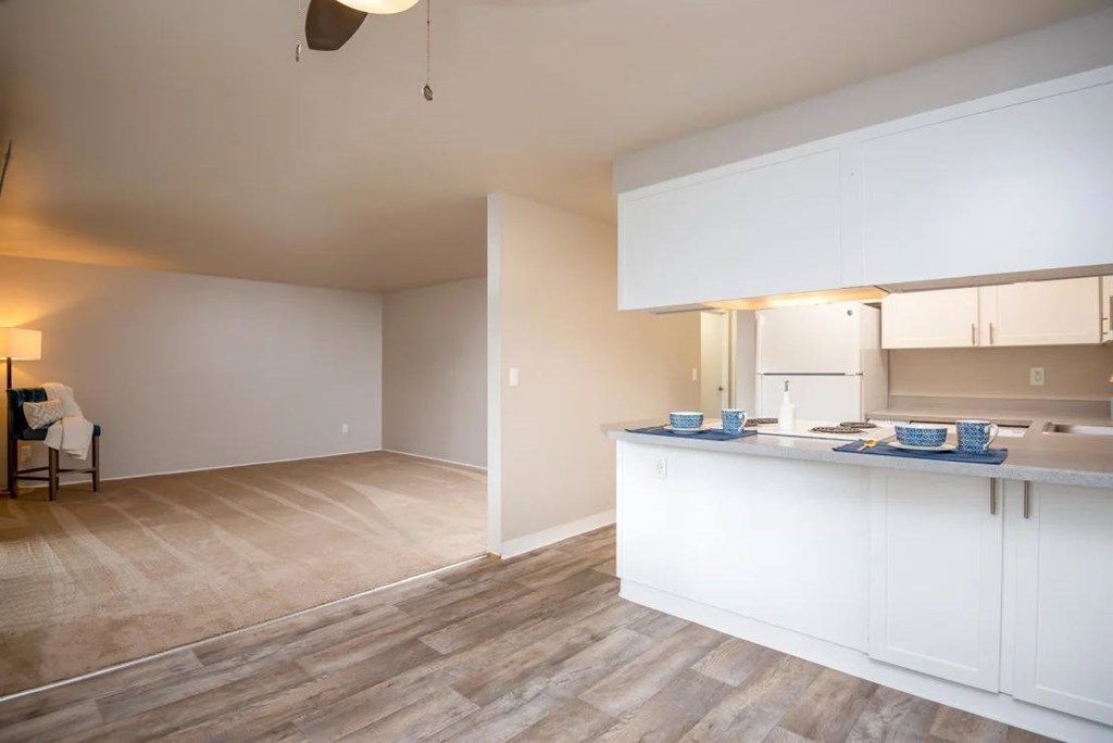 A kitchen with a dining table and chairs in the living room.