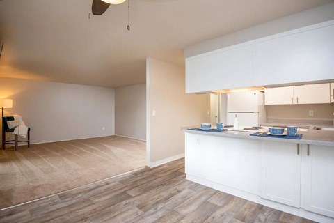 A kitchen with a dining table and chairs in the living room.