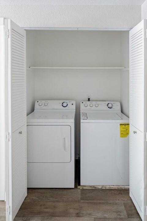 A small laundry room with a washer and dryer.