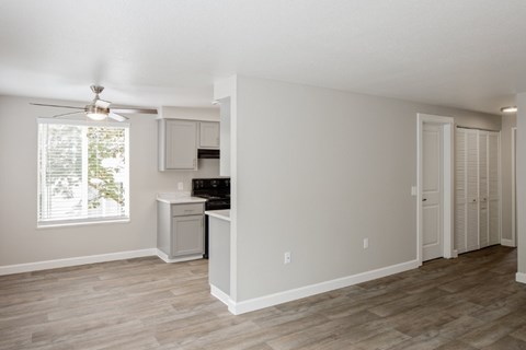 A kitchen area with a ceiling fan and a window.
