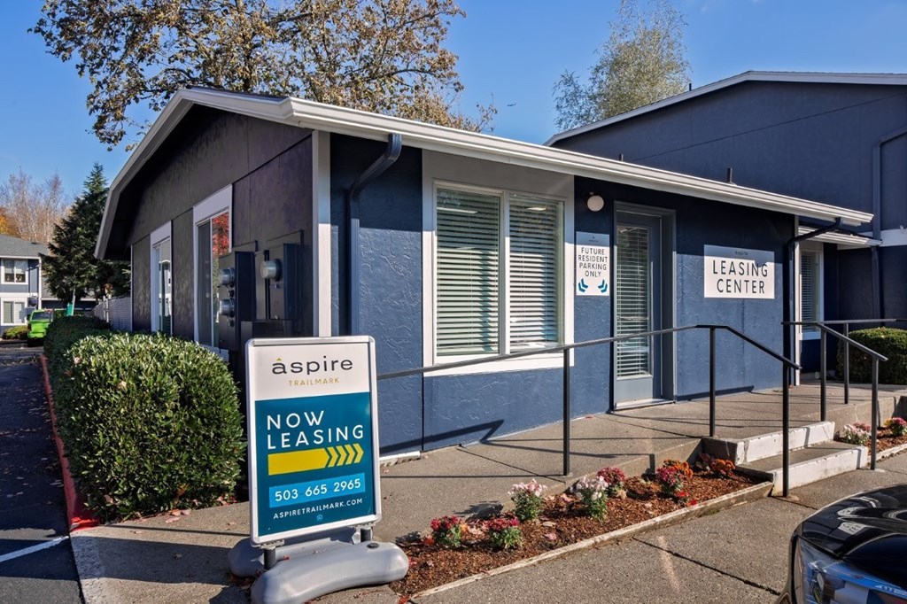 A blue building with a sign that says "aspire leasing center".